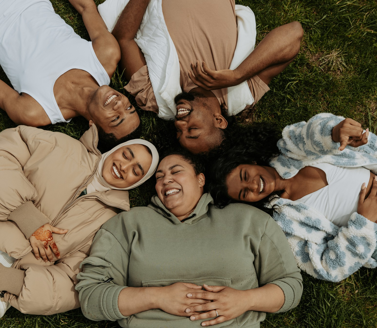 Group of people lying on grass